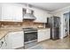 Modern kitchen with white cabinets, stainless steel appliances, and granite counters at 4944 Cornelia Dr, Charlotte, NC 28269