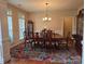 Elegant dining room with chandelier, large table, and floral rug at 5421 Roberta Meadows Ct, Concord, NC 28027