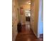 Inviting hallway view with wood floors, leading to the kitchen with wood cabinets at 5421 Roberta Meadows Ct, Concord, NC 28027