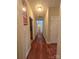 Inviting hallway with gleaming hardwood floors, neutral walls, and access to various rooms at 5421 Roberta Meadows Ct, Concord, NC 28027