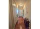 Hallway with hardwood floors, multiple doors, and neutral paint at 5421 Roberta Meadows Ct, Concord, NC 28027