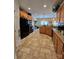 Bright kitchen featuring wooden cabinets, granite countertops, and tile flooring at 5421 Roberta Meadows Ct, Concord, NC 28027