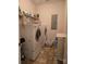 Practical laundry room includes a washer, a dryer, and storage shelves at 5421 Roberta Meadows Ct, Concord, NC 28027