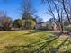 Large backyard with deck and mature trees at 6412 Wheeler Dr, Charlotte, NC 28211