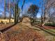 Wooden shed nestled in a wooded backyard at 6412 Wheeler Dr, Charlotte, NC 28211