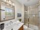 Updated bathroom with a glass shower and tile flooring at 6412 Wheeler Dr, Charlotte, NC 28211