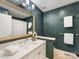 Modern bathroom with dark green walls and white vanity at 6412 Wheeler Dr, Charlotte, NC 28211