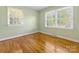 Bright bedroom with hardwood floors and multiple windows at 6412 Wheeler Dr, Charlotte, NC 28211