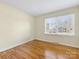 Well-lit bedroom featuring hardwood floors and window at 6412 Wheeler Dr, Charlotte, NC 28211