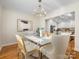 Elegant dining room with chandelier and view into the kitchen at 6412 Wheeler Dr, Charlotte, NC 28211