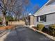 Home's exterior showcasing a gray brick facade and driveway at 6412 Wheeler Dr, Charlotte, NC 28211