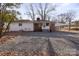 Ranch home with carport, gravel driveway, and fenced yard at 6475 Highway 73 E Hwy, Mount Pleasant, NC 28124