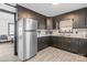 Modern kitchen with dark cabinetry, stainless steel appliances, and a breakfast bar at 6475 Highway 73 E Hwy, Mount Pleasant, NC 28124