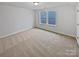 Spacious bedroom with neutral carpeting and large windows at 744 Bartram Ave, Concord, NC 28025