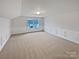 Spacious bedroom with wainscoting and neutral carpet at 744 Bartram Ave, Concord, NC 28025