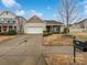 Beige house with two-car garage and landscaping at 744 Bartram Ave, Concord, NC 28025