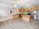 Kitchen with island, stainless steel appliances, and light wood cabinets at 744 Bartram Ave, Concord, NC 28025