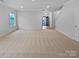 Large living room with beige carpet and entryway view at 744 Bartram Ave, Concord, NC 28025