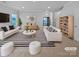 Spacious living room with white sofas and striped rug at 744 Bartram Ave, Concord, NC 28025