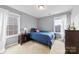 Cozy bedroom with dark wood furniture, blue bedding, and plenty of natural light at 8023 Alford Rd, Fort Mill, SC 29707