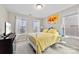 Charming bedroom with yellow bedding, white metal frame bed, and ample natural light at 8023 Alford Rd, Fort Mill, SC 29707