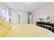 Bright bedroom with yellow bedding, TV, and double door closet at 8023 Alford Rd, Fort Mill, SC 29707