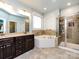 Luxurious bathroom featuring double vanity, soaking tub and separate shower at 8177 Breton Way, Harrisburg, NC 28075