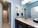 Bathroom featuring a granite-topped vanity, updated fixtures, and a view into the connecting room at 8177 Breton Way, Harrisburg, NC 28075