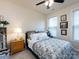 Bedroom with a large window providing natural light, a ceiling fan, and carpeted floors at 8177 Breton Way, Harrisburg, NC 28075