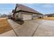 Exterior view of the home featuring a large garage and a well-manicured lawn at 8177 Breton Way, Harrisburg, NC 28075