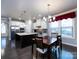 Spacious kitchen area with island, dining table, and stainless steel appliances at 8177 Breton Way, Harrisburg, NC 28075