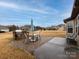 Exterior patio featuring a stone BBQ, outdoor furniture, and beautiful green lawn at 8177 Breton Way, Harrisburg, NC 28075