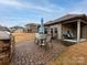 Exterior patio featuring a stone BBQ, outdoor furniture, and beautiful green lawn at 8177 Breton Way, Harrisburg, NC 28075