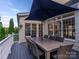 Relaxing back deck with a large dining table and umbrella at 9 Pine Tree Rd, Salisbury, NC 28144