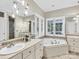 Elegant bathroom with double vanity, soaking tub, and large windows at 9 Pine Tree Rd, Salisbury, NC 28144