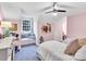 Pink and gray bedroom with twin beds, built in shelving and window seat at 9 Pine Tree Rd, Salisbury, NC 28144