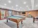 Spacious game room with pool table, seating area, and brick accent wall at 9 Pine Tree Rd, Salisbury, NC 28144