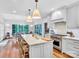 Bright kitchen with white cabinets, marble countertops, and a herringbone backsplash at 9 Pine Tree Rd, Salisbury, NC 28144