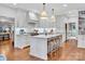 Modern kitchen with white cabinetry, marble island, and hardwood floors at 9 Pine Tree Rd, Salisbury, NC 28144