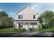 Two-story Craftsman home with light beige siding, and a covered front porch at Lot 1 W Mauney Ave, Gastonia, NC 28052