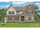 Two-story house with stone and light beige vinyl siding, and a two-car garage at Lot 113 Mayes Meadow Dr # Covington, Cornelius, NC 28078