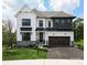 Two-story white house with a dark gray roof, stone accents, and a two-car garage at Lot 113 Mayes Meadow Dr # Covington, Cornelius, NC 28078