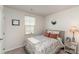 Bedroom with floral bedding, nightstand, and window at 107 Harborough Ave, Troutman, NC 28166