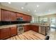 Well-lit kitchen features stainless steel appliances, dark cabinets, granite countertops, and a breakfast area at 1356 Middlecrest Dr, Concord, NC 28027