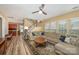 Spacious living room featuring a large sectional sofa, hardwood floors, and a ceiling fan at 1356 Middlecrest Dr, Concord, NC 28027