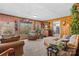 A wood paneled living room featuring carpet flooring, comfortable seating, and a large picture window at 1517 Cuthbertson Rd, Waxhaw, NC 28173