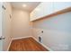 Bright laundry room with white cabinets and wood-look flooring at 152 Suggs Mill Dr, Mooresville, NC 28115