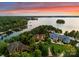 Stunning aerial view of lakeside estate with lush landscaping and picturesque sunset over the water at 155 Union Chapel Dr, Mooresville, NC 28117