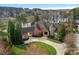 Aerial view of estate showcasing lush landscaping, circular drive and mature trees with waterfront views at 155 Union Chapel Dr, Mooresville, NC 28117