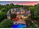 Luxury home with pool and lake view at sunset at 155 Union Chapel Dr, Mooresville, NC 28117